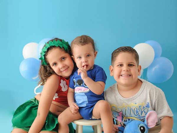 Diverse group of smiling children sitting on colorful yoga mats.